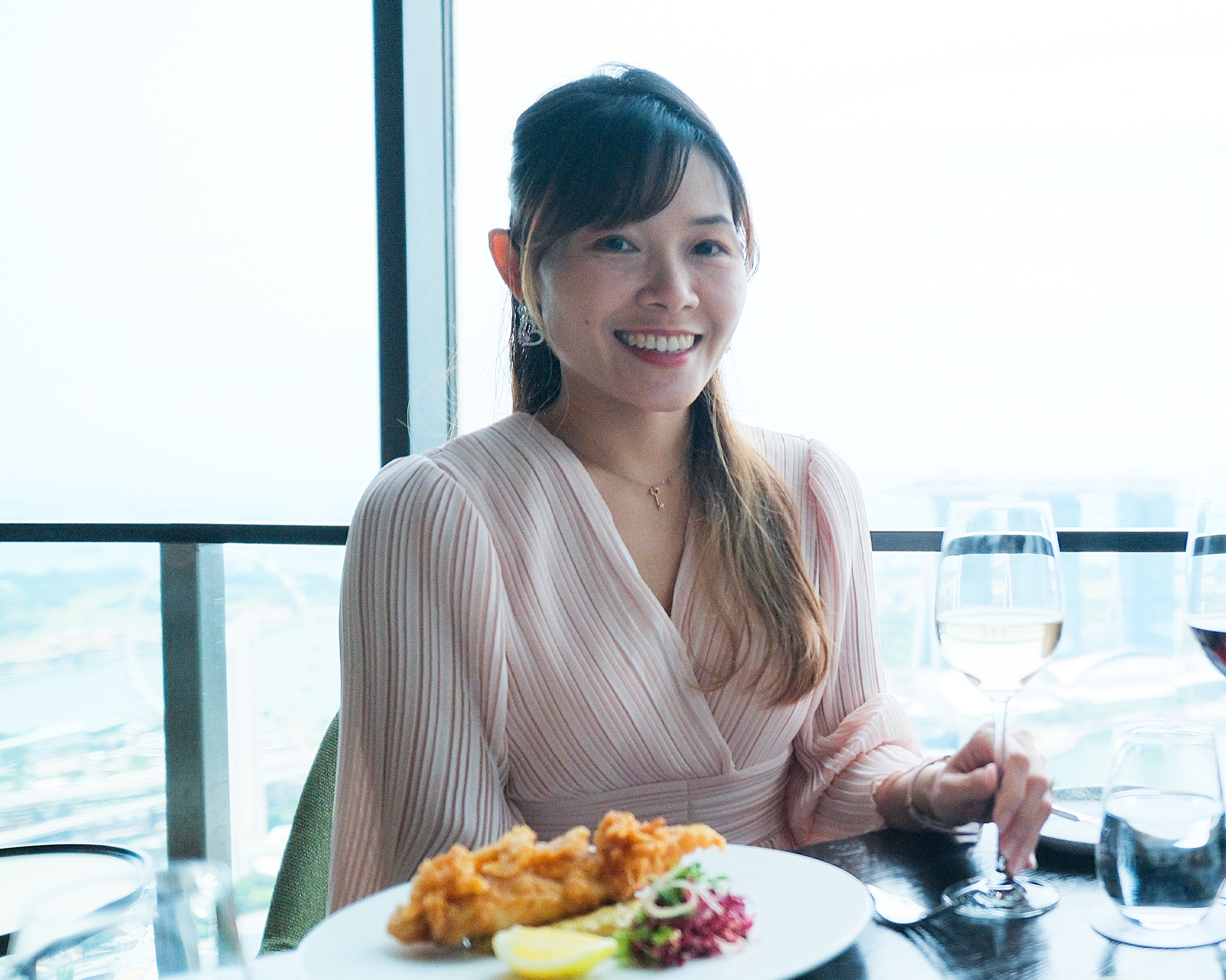 Xinli enjoying Accor Plus membership benefits with gourmet food and wine at Swissôtel The Stamford Singapore.